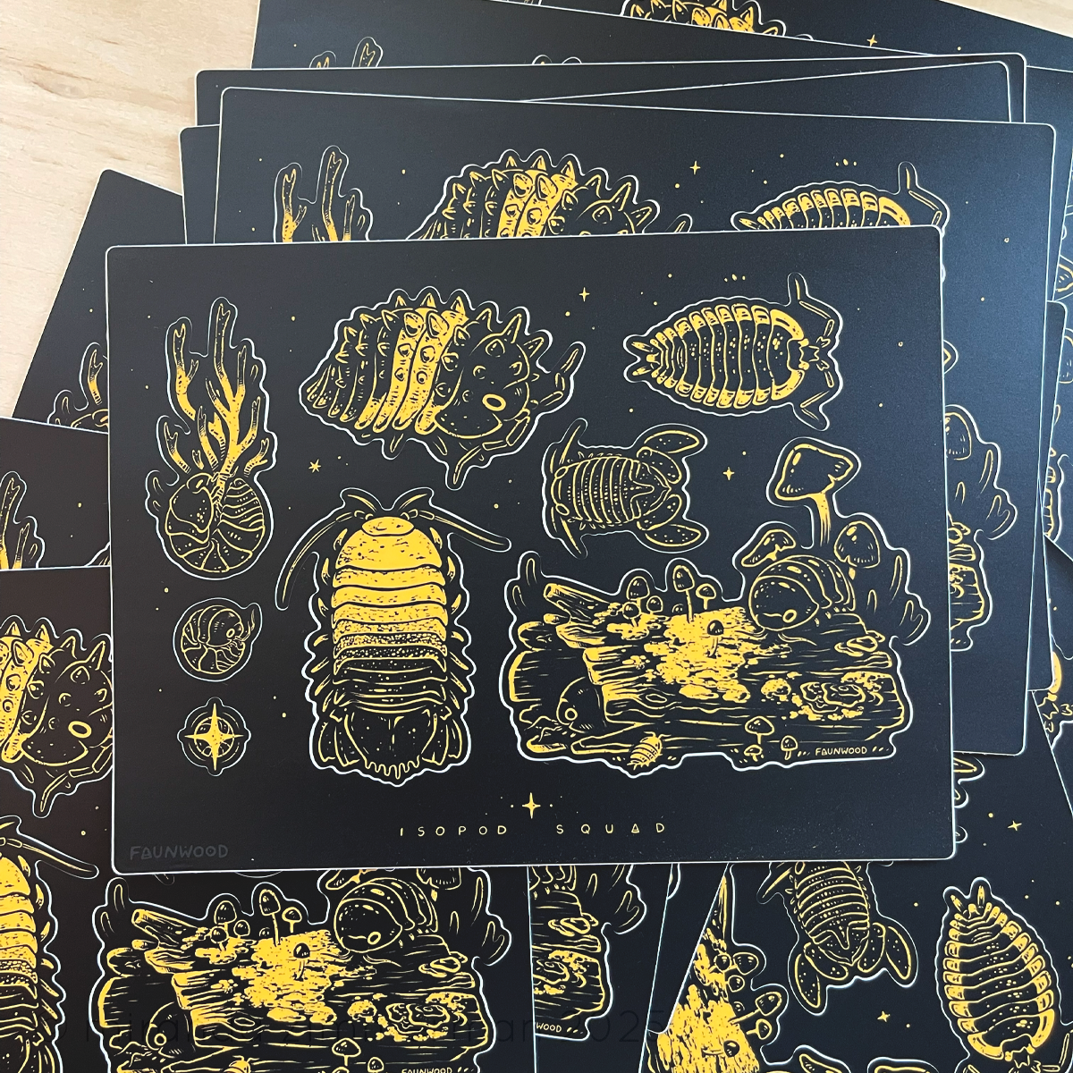 Several matte vinyl stickers sheet with several black and yellow isopod illustrations. This listing is for a single sheet, even though more are shown in this photo.
