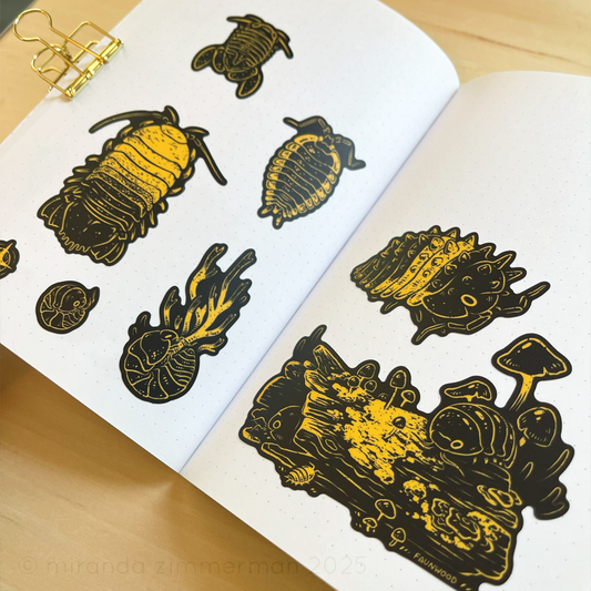 A photo showing the individual stickers removed from the sticker sheet and placed in a notebook to show how they look individually.