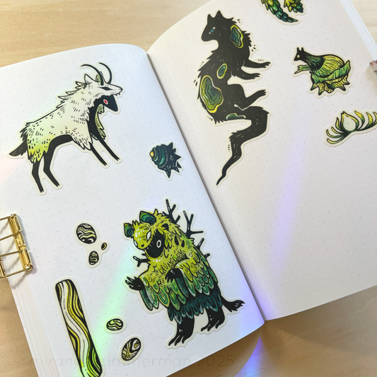 A photo showing the individual stickers removed from the sheet and placed in a notebook. The purpose of the photo is to show what the stickers look like individually.