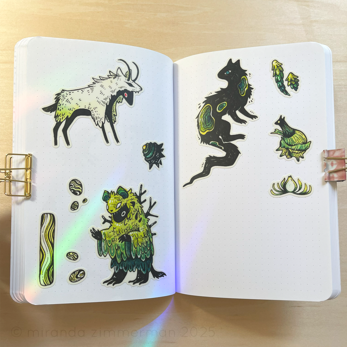 A photo showing the individual stickers removed from the sheet and placed in a notebook. The purpose of the photo is to show what the stickers look like individually.