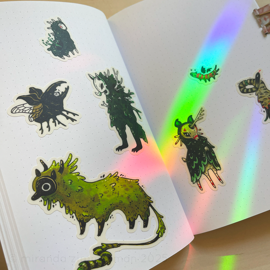 A photo of the individual stickers removed from the original sticker sheet and placed in a notebook, to show what they look like separately.