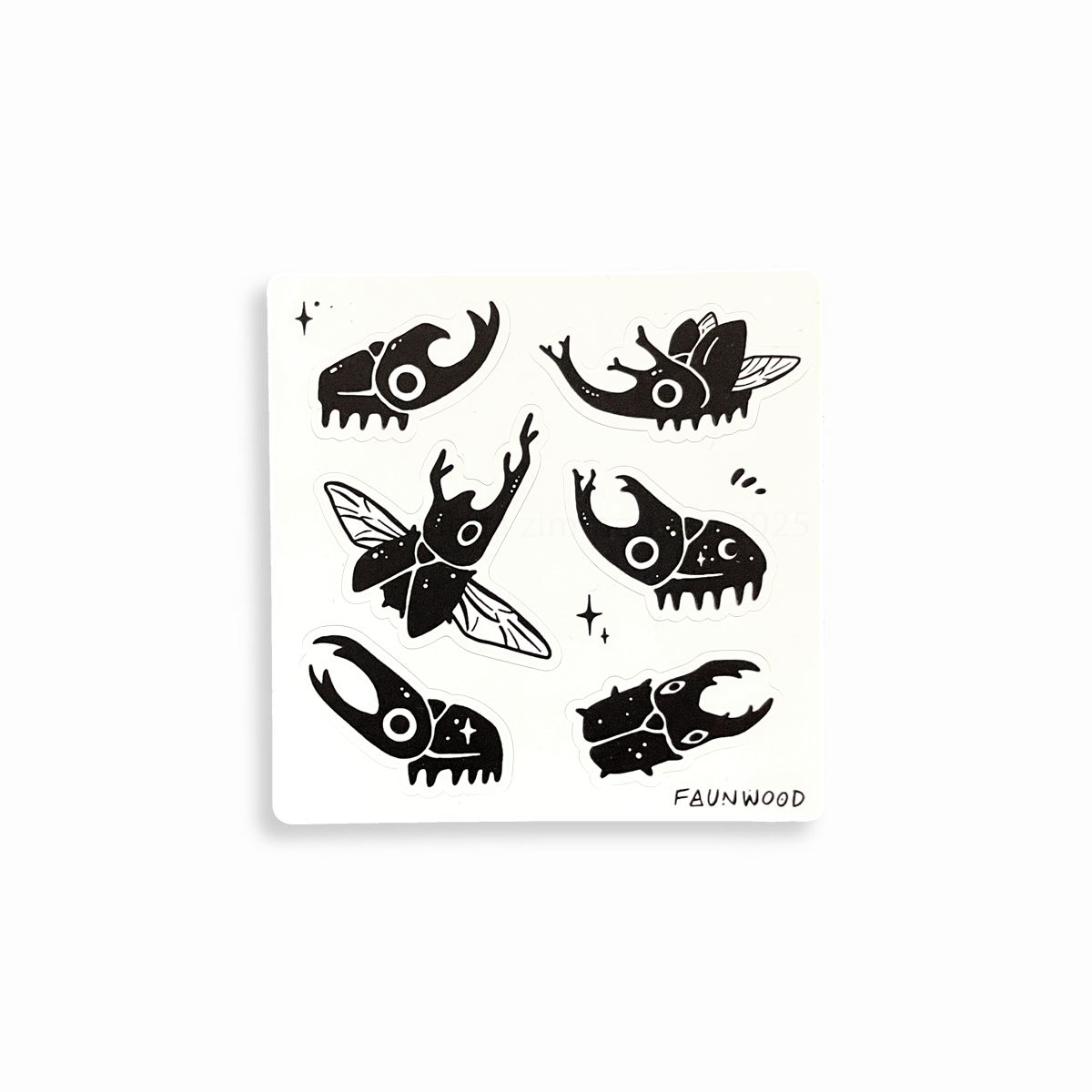 A matte vinyl sticker sheet with six different black beetle illustration stickers.