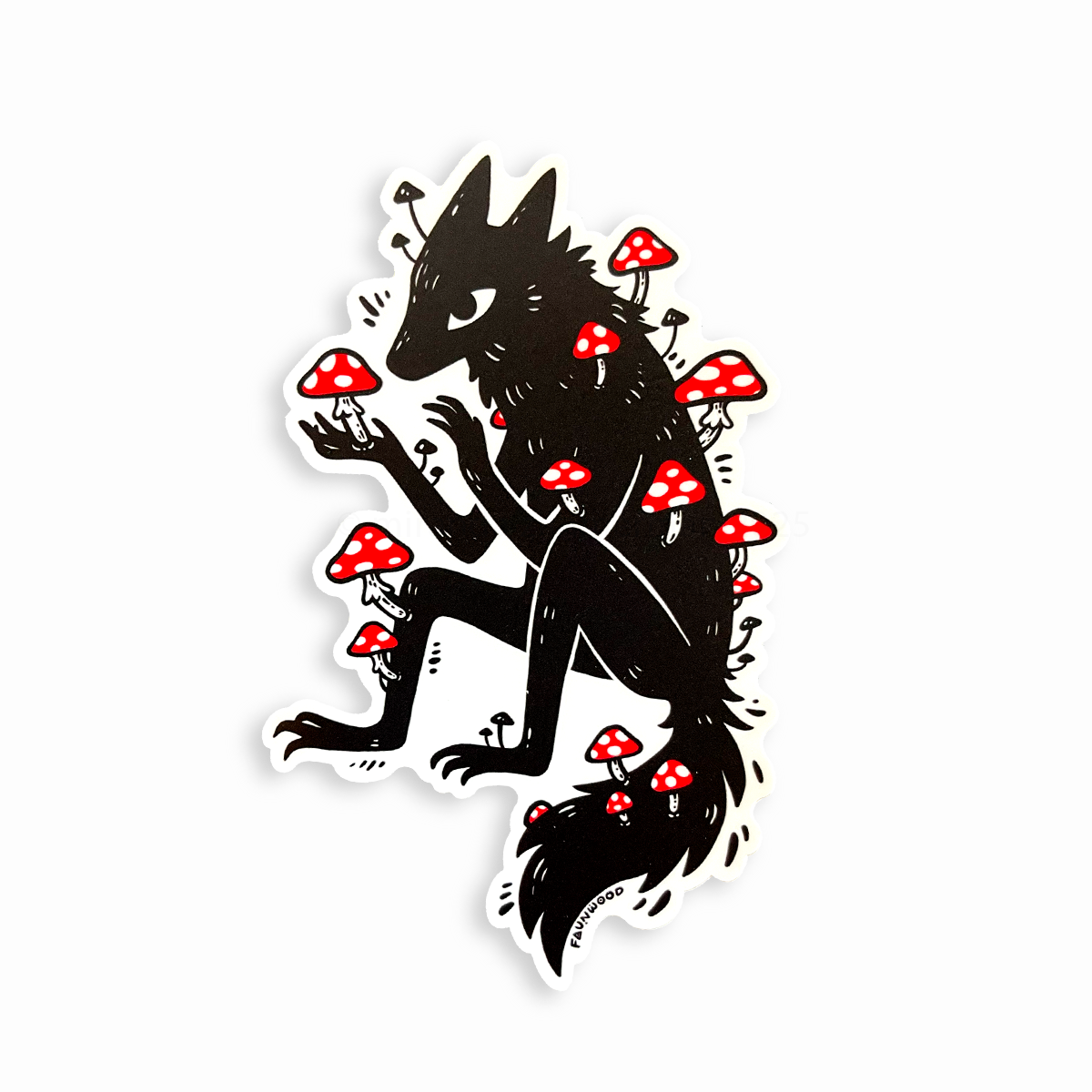 A matte vinyl sticker featuring a black illustration of a wolfy fox covered in red amanita mushrooms.
