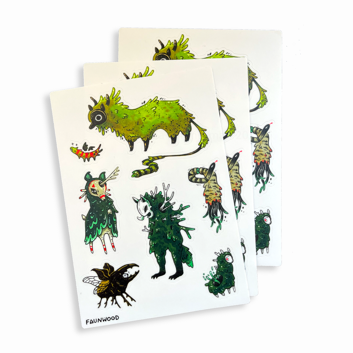 Three sticker sheets with seven different mossy and green creature designs, illustrated with ink and markers.  This listing is for a single sheet, even though three are pictured here.