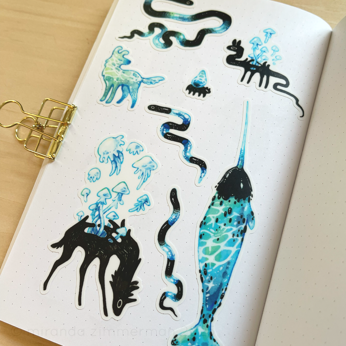 A photo showing the individual stickers removed from the sticker sheet and placed in a notebook.  This is meant to show how the stickers look separately.