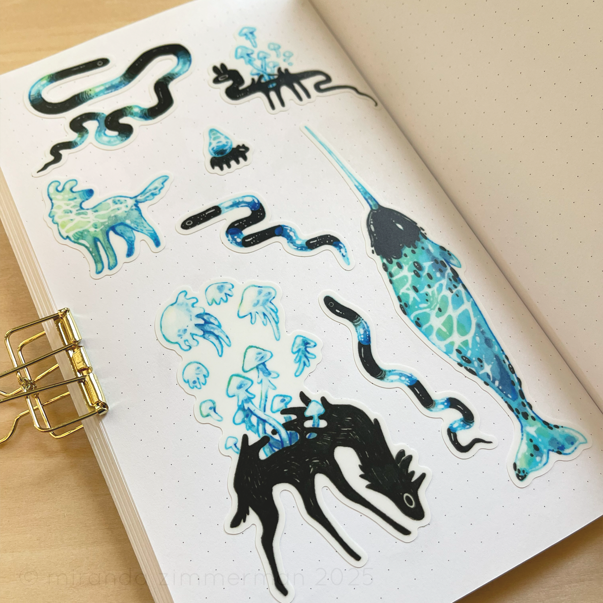 A photo showing the individual stickers removed from the sticker sheet and placed in a notebook.  This is meant to show how the stickers look separately.